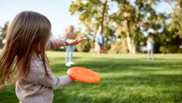 making memories breaking the distance little girl playing frisbee picture id1192723559 1.jpg